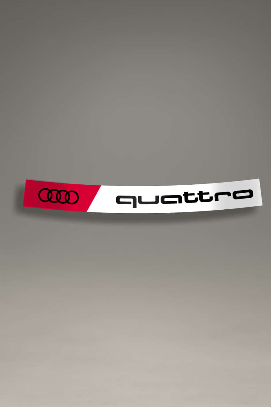 Parasol de vinilo para coche con diseño Audi Quattro en negro sobre fondo blanco y rojo. Accesorio de personalización de MOA-Grafics con estilo racing para protección solar.