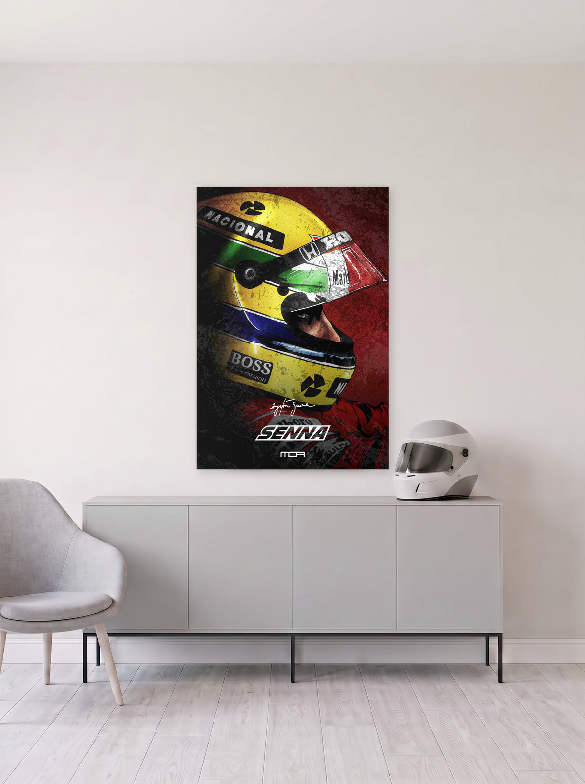 Poster del casco de Ayrton Senna sobre fondo rojo, colgado en la pared clara de un salon, sobre un aparador gris con un casco de competicion al lado, decoracion racing de MOA-Grafics.