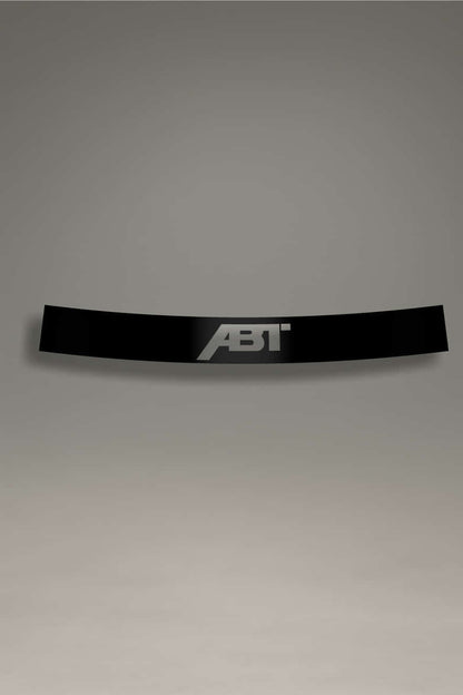 Parasol de vinilo Audi con logo ABT recortado en negro sobre fondo transparente. Accesorio de parabrisas con protección solar.