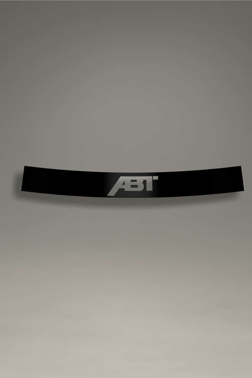 Parasol de vinilo Audi con logo ABT recortado en negro sobre fondo transparente. Accesorio de parabrisas con protección solar.