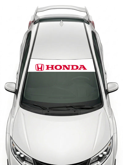 Parasol de vinilo Honda blanco con el emblema H y el lettering HONDA en rojo, instalado en el parabrisas de un Honda Civic blanco