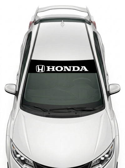 Parasol de vinilo Honda negro con el emblema H y el lettering HONDA en blanco, instalado en el parabrisas de un Honda Civic blanco