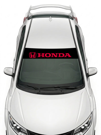 Parasol de vinilo Honda negro con el emblema H y el lettering HONDA en rojo, instalado en el parabrisas de un Honda Civic blanco