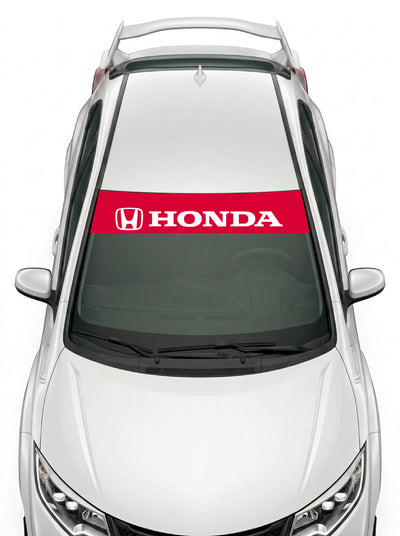 Parasol de vinilo Honda rojo con el emblema H y el lettering HONDA en blanco, instalado en el parabrisas de un Honda Civic blanco