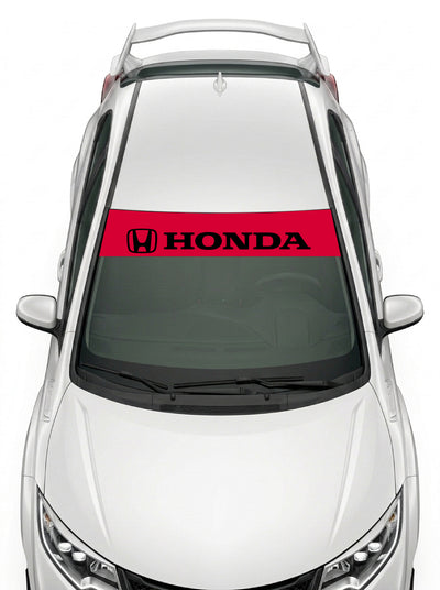 Parasol de vinilo Honda rojo con el emblema H y el lettering HONDA en negro, instalado en el parabrisas de un Honda Civic blanco
