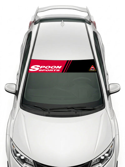 Parasol de vinilo Honda negro con las franjas de Spoon Sports en rojo y blanco, instalado en el parabrisas de un Honda Civic blanco