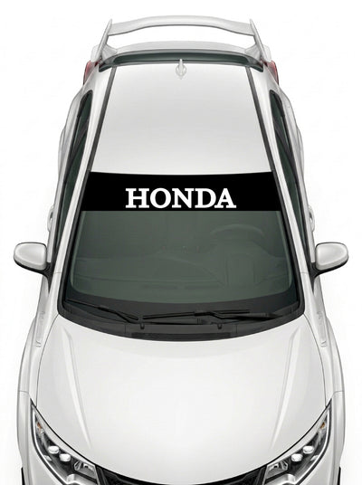 Parasol de vinilo Honda negro con el lettering HONDA en blanco, instalado en el parabrisas de un Honda Civic blanco