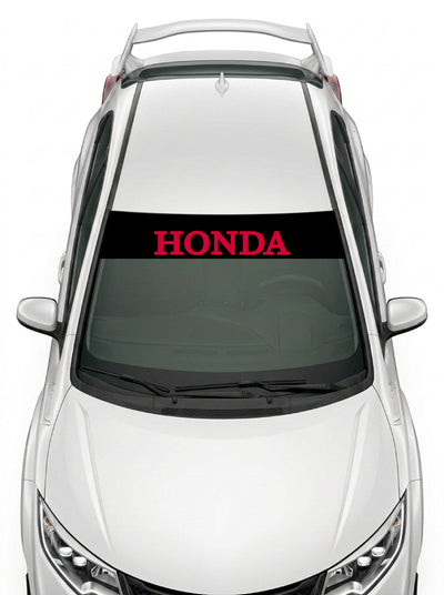 Parasol de vinilo Honda negro con el lettering HONDA en rojo, instalado en el parabrisas de un Honda Civic blanco