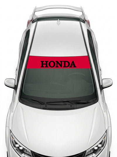 Parasol de vinilo Honda rojo con el lettering HONDA en negro, instalado en el parabrisas de un Honda Civic blanco