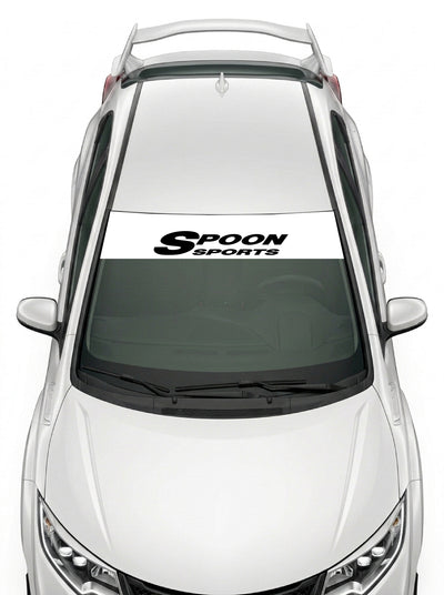 Parasol de vinilo Honda blanco con el logotipo del preparador Spoon Sports en negro, instalado en el parabrisas de un Honda Civic blanco