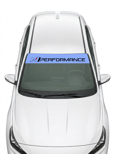 Parasol de vinilo Hyundai N Performance azul con el lettering en blanco, instalado en el parabrisas de un Hyundai blanco