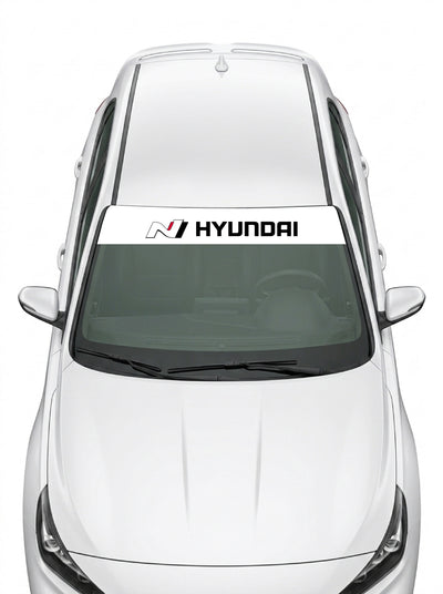 Parasol de vinilo Hyundai N blanco con el logo N y el lettering HYUNDAI, instalado en el parabrisas de un Hyundai blanco