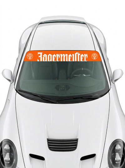 Coche con el parasol de vinilo Jagermeister naranja con el lettering en blanco y el escudo del ciervo a los dos lados instalado en el parabrisas