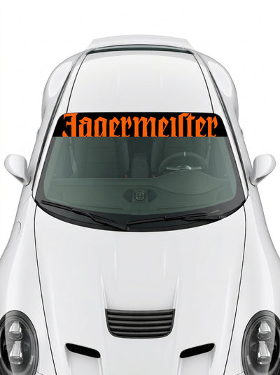 Coche con el parasol de vinilo Jagermeister negro con el lettering en naranja a todo lo ancho instalado en el parabrisas