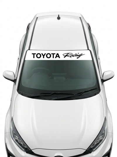 Coche con el parasol de vinilo Toyota blanco con el lettering TOYOTA Racing en negro y la palabra Racing manuscrita instalado en el parabrisas