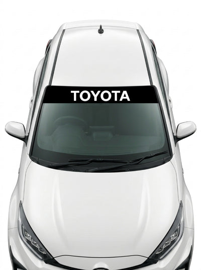 Coche con el parasol de vinilo Toyota negro con el lettering TOYOTA en blanco instalado en el parabrisas