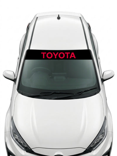 Coche con el parasol de vinilo Toyota negro con el lettering TOYOTA en rojo instalado en el parabrisas
