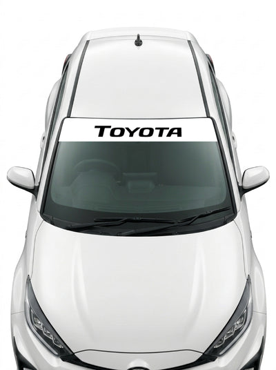 Coche con el parasol de vinilo Toyota blanco con el lettering TOYOTA en negro y tipografia italica estrecha instalado en el parabrisas