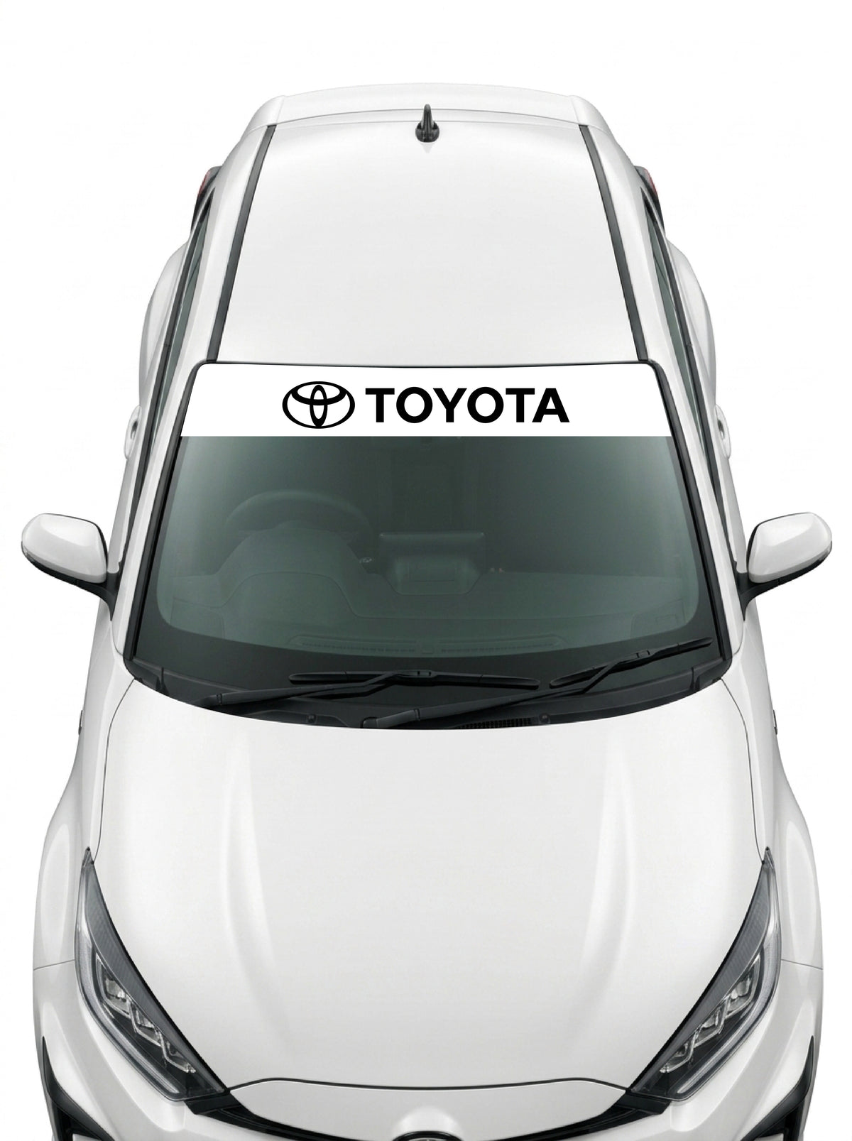 Coche con el parasol de vinilo Toyota blanco con el emblema de los tres ovalos y el lettering TOYOTA en negro instalado en el parabrisas