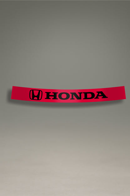 Parasol de vinilo rojo con el logotipo oficial de Honda en negro. Un accesorio de estilo deportivo de MOA-Grafics para proteger y personalizar tu vehículo.