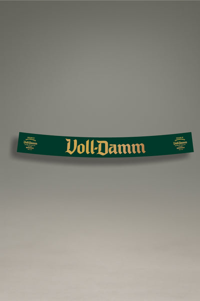 Parasol de vinilo verde con el logotipo premium de Voll-Damm en dorado. Un accesorio de MOA-Grafics para personalizar tu coche y protegerlo del sol.