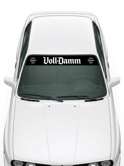 Coche con el parasol de vinilo Voll-Damm negro con el lettering en blanco y los sellos de la edicion 70 aniversario a los dos lados instalado en el parabrisas
