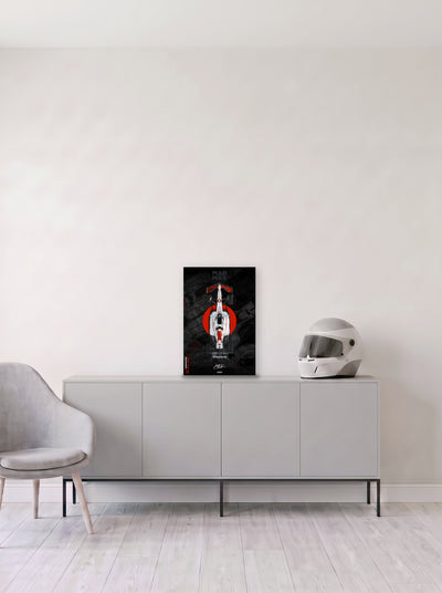 Poster del Red Bull de Max Verstappen sobre un circulo rojo, en homenaje al Gran Premio de Japon, en medida 33,3 x 50 cm, apoyado sobre un aparador gris junto a un casco de competicion, decoracion racing de MOA-Grafics.