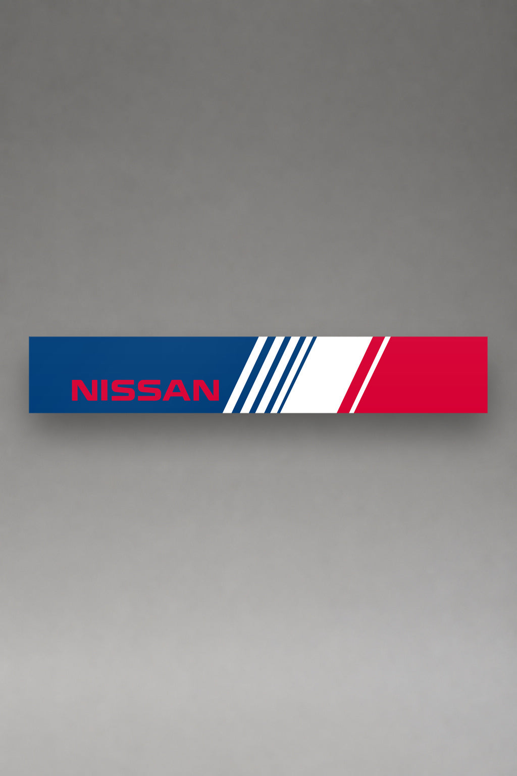 Parasol de vinilo Nissan con la livery lateral tricolor de los ochenta, la tira entera vista de frente, de MOA-Grafics.