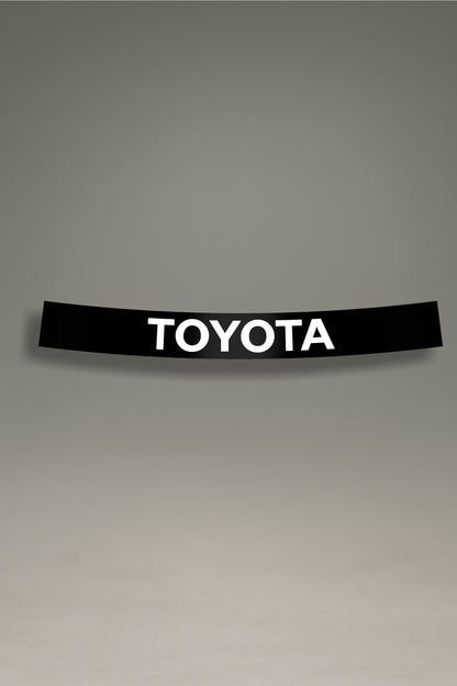 Parasol negro para parabrisas con el logo de Toyota en blanco, un accesorio de estilo JDM para personalización de coches de MOA-Grafics.